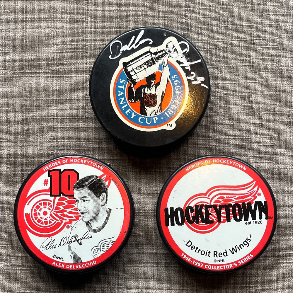 3 Collectable Detroit Red Wings Hockey Pucks 1 Signed